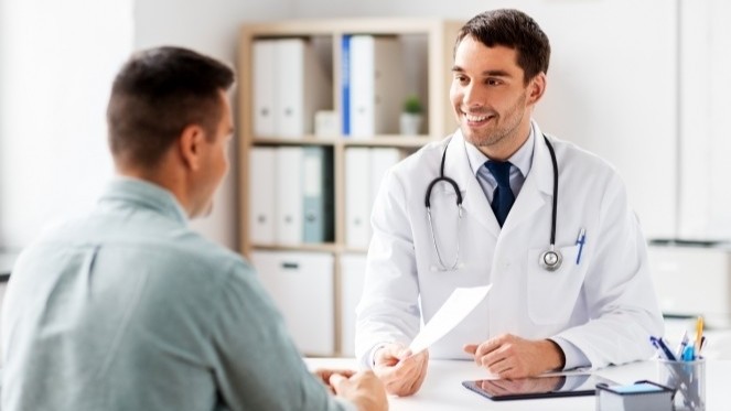 Healthcare professional discussing treatment planning with a patient, highlighting care management strategies that improve outcomes and reduce avoidable costs.